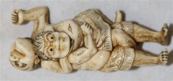 A Japanese ivory netsuke of two sumo wrestlers, 19th century, 5.8cm